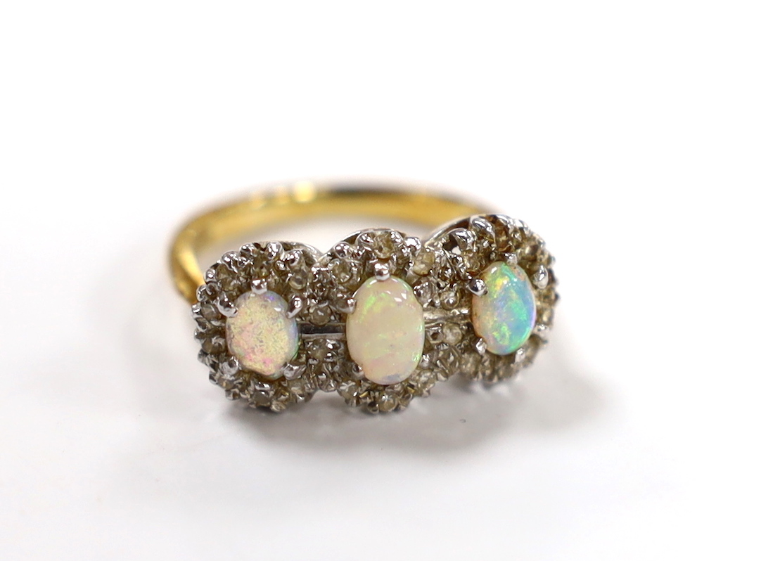 An 18ct, white opal and diamond chip set triple cluster dress ring, size K, gross weight 4.2 grams.